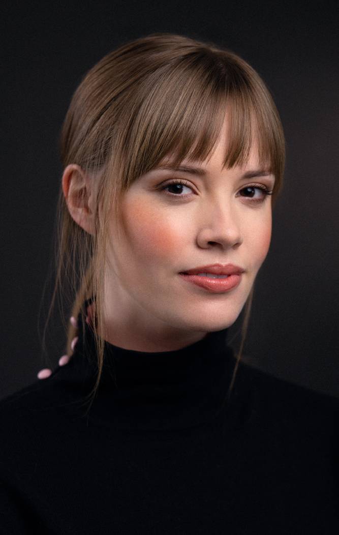 A photograph of producer and moss theatre collective member, Cassidy Sadler. Wearing a black turtleneck.