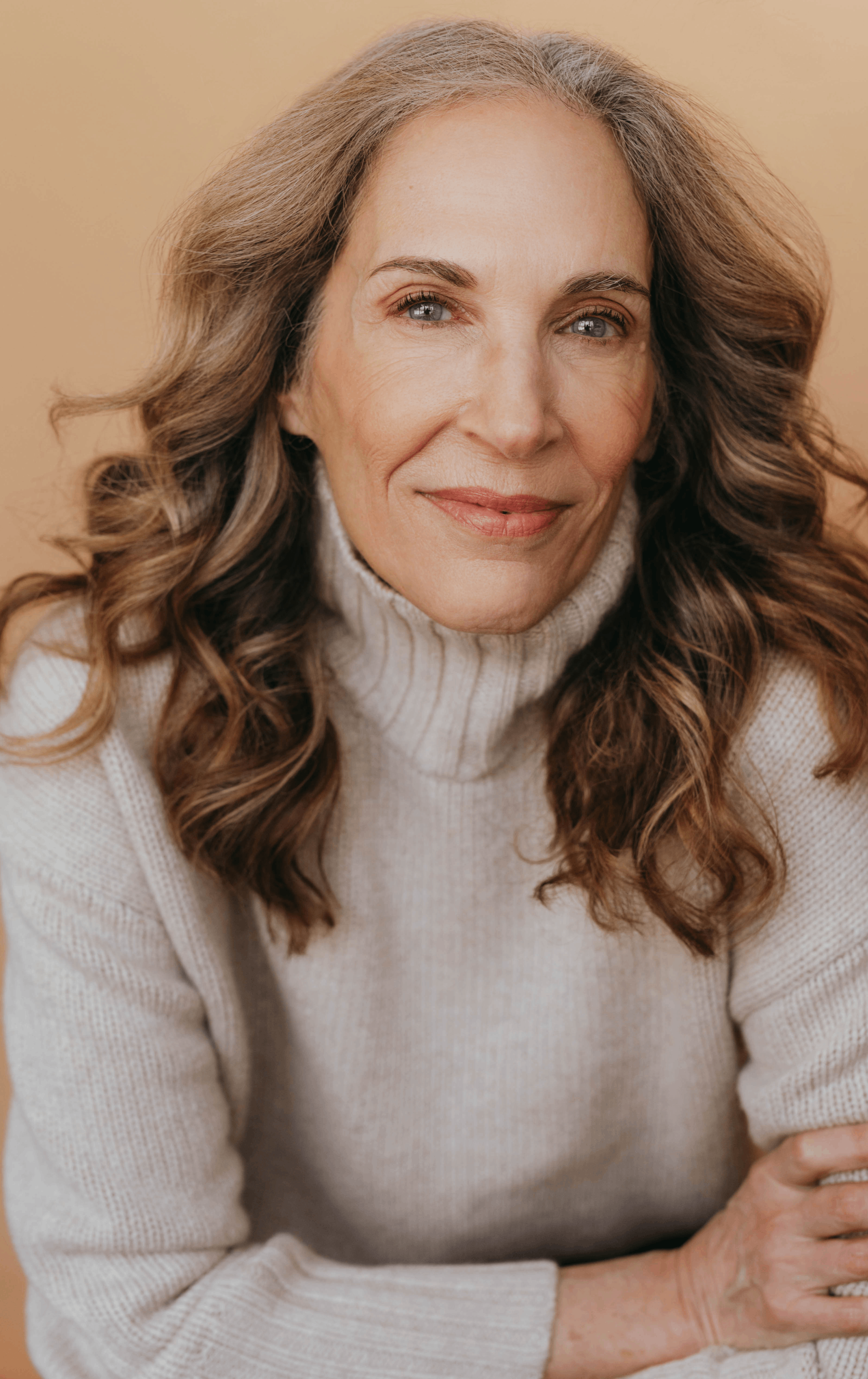 A photograph of actress Liz Best in a tan turtleneck.